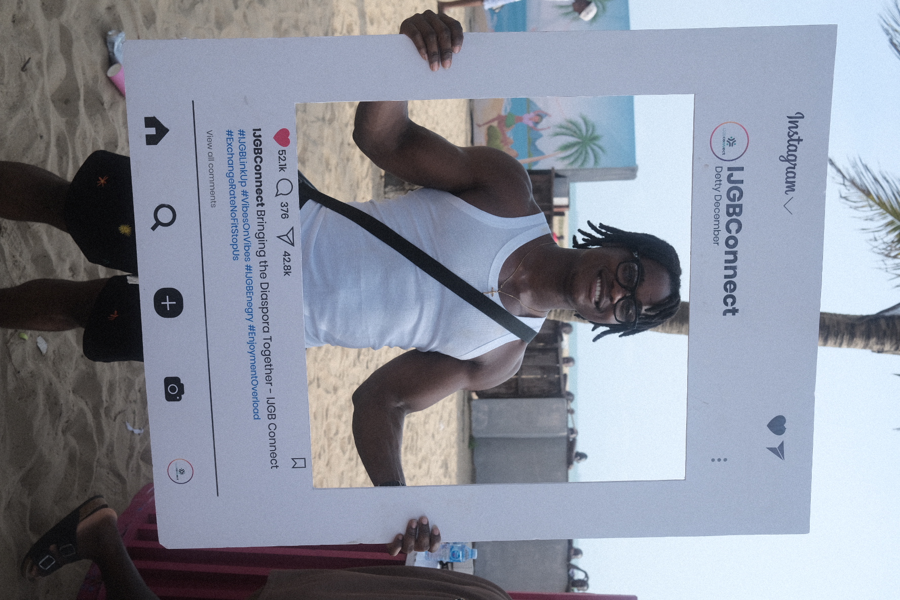 IJGB Connect Detty December — guest posing with the IJGBConnect Instagram frame on the beach