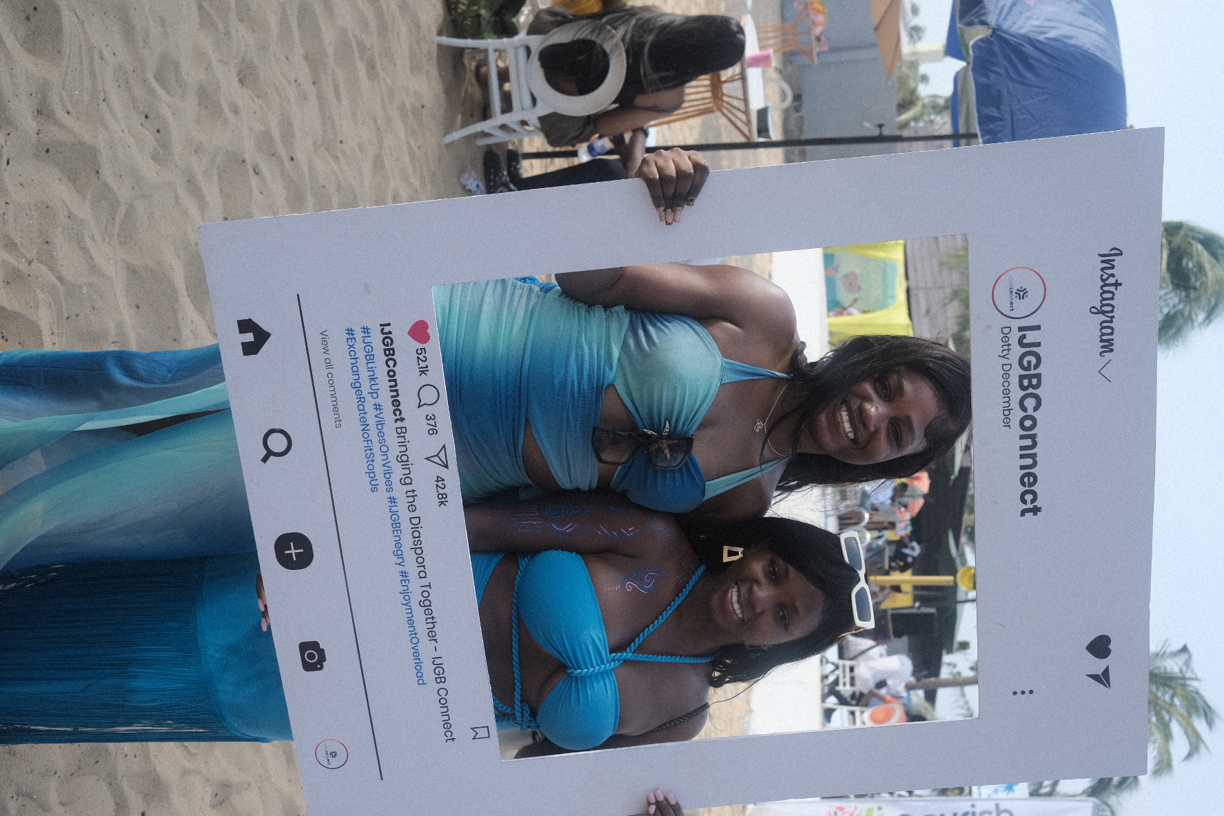 IJGB Connect Detty December — friends posing with the IJGBConnect Instagram frame at the beach party