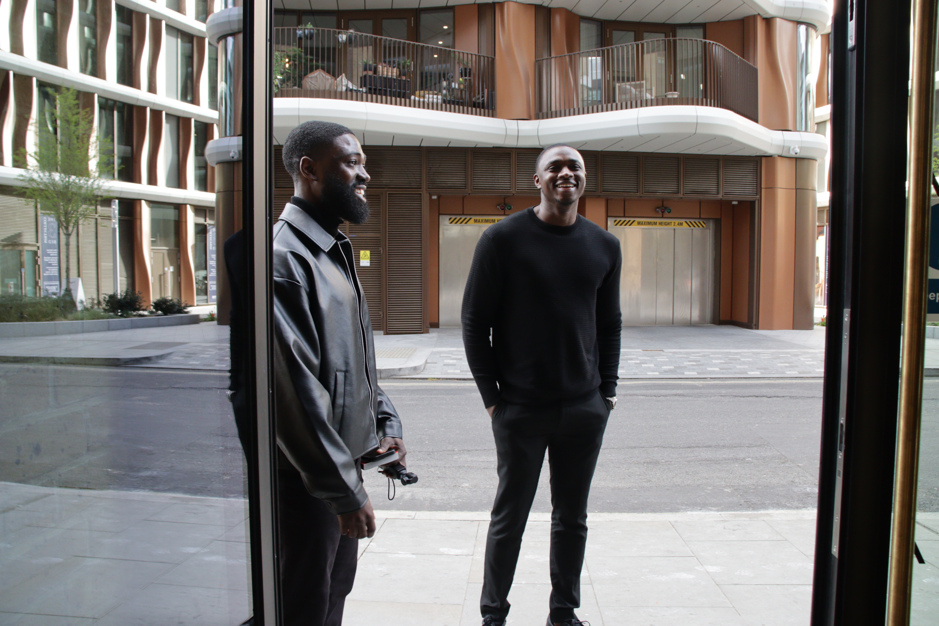 IJGB Connect founders — two team members standing in a modern London courtyard