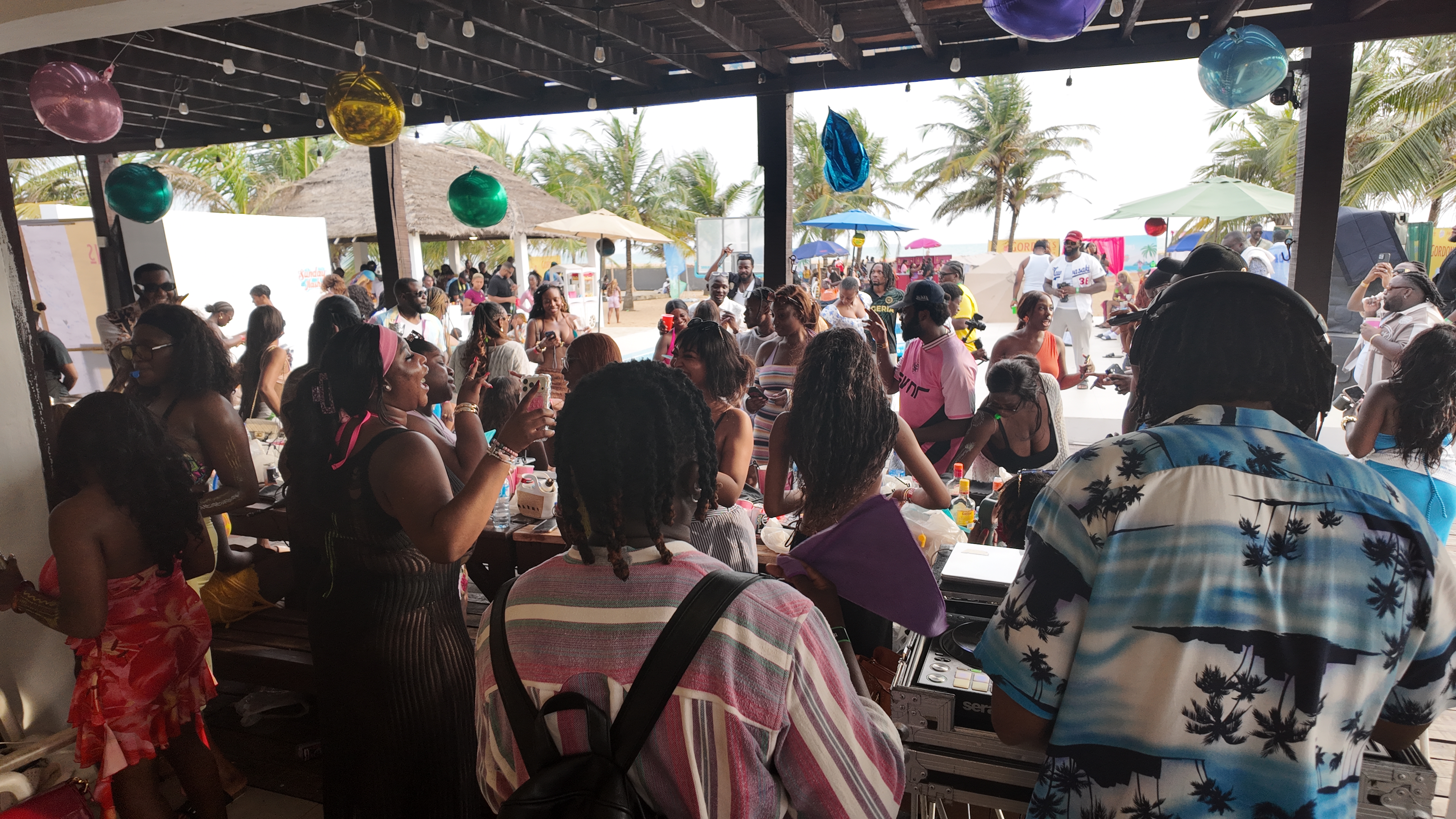 IJGB Connect beach day — DJ set with the crowd dancing under colourful baubles in Lagos