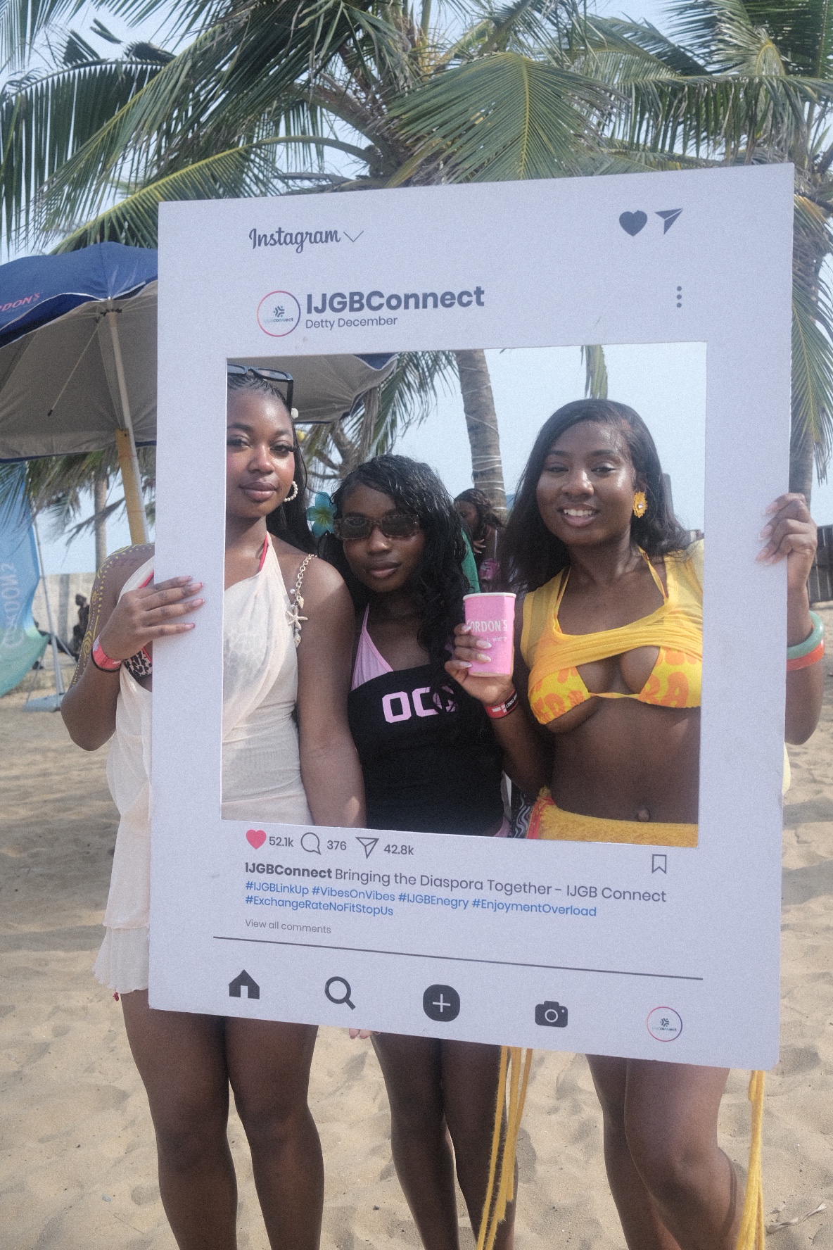 IJGB Connect Detty December — three friends posing with the IJGBConnect Instagram frame on the beach